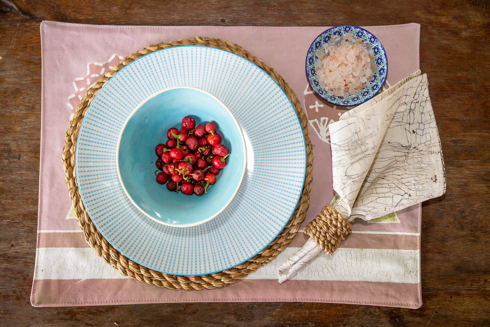 peachy pink hand made and hand painted tablemats made from organic cotton in zambia