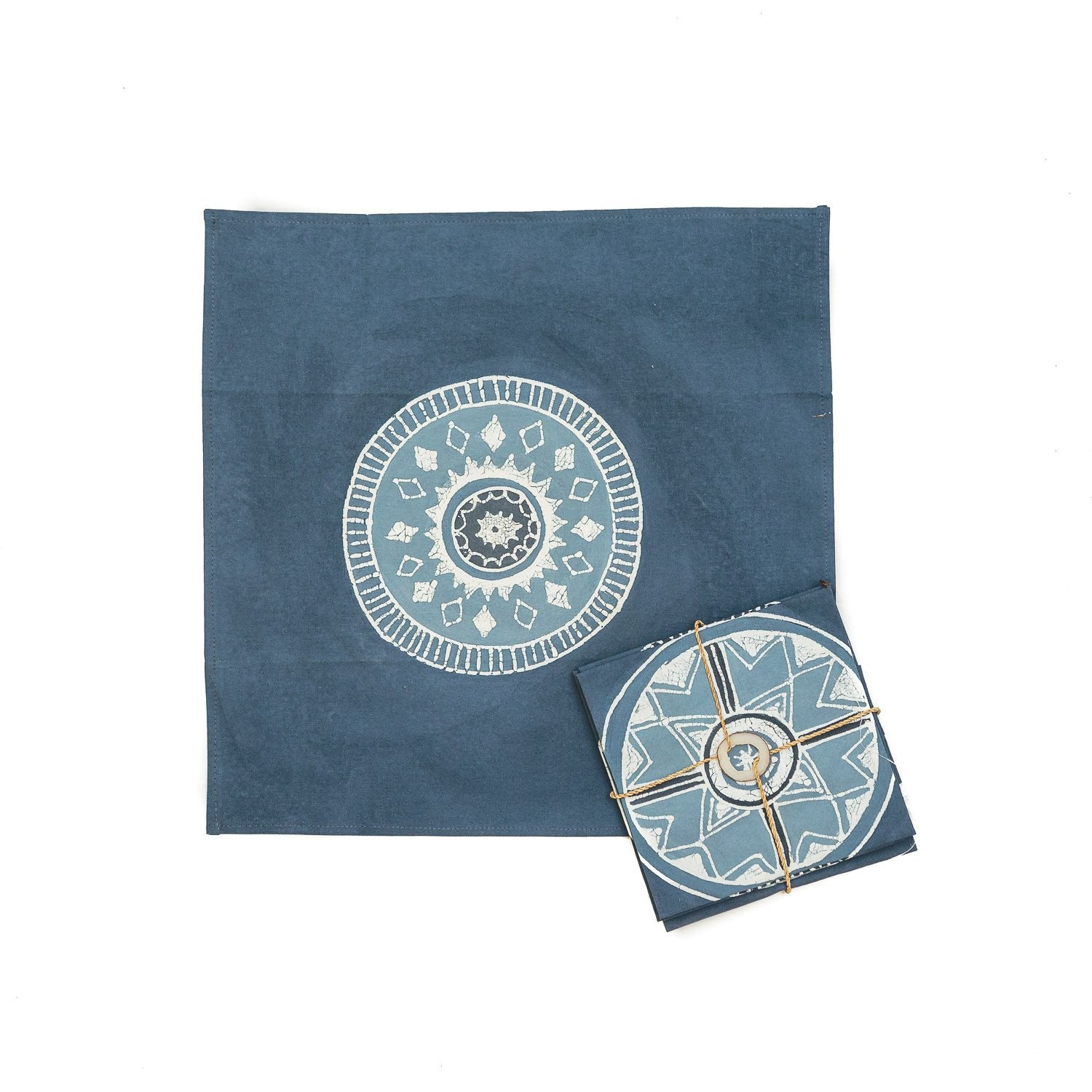 The perfect indigo napkins adorned with detailed circular patterns and gold accents on 100% cotton.