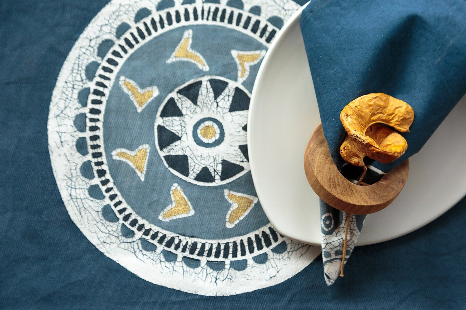 The perfect elegant blue napkins adorned with a chic circular pattern, teal and gold accents, inspired by African beauty.