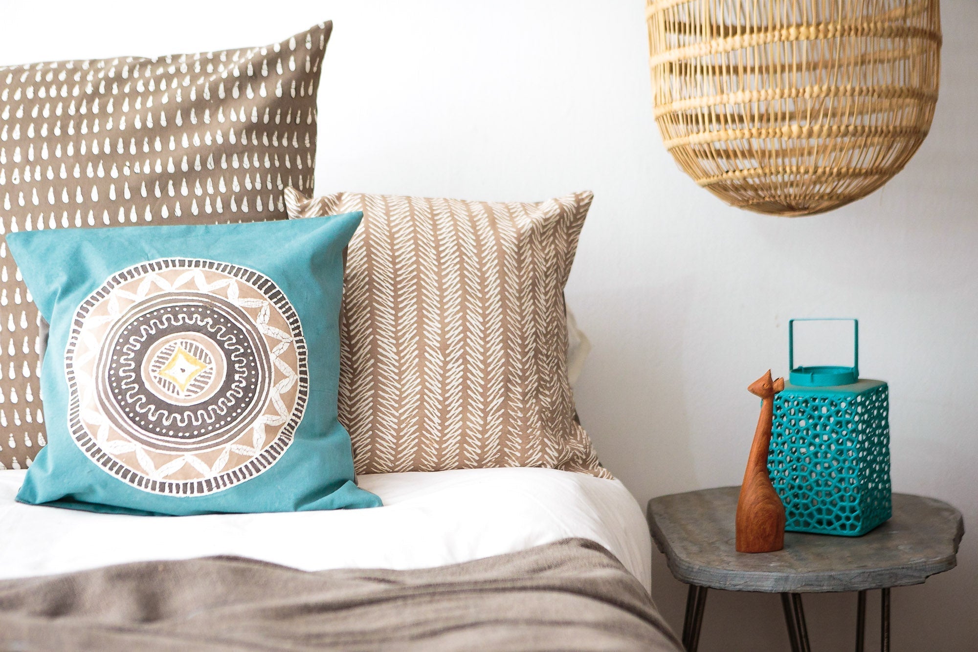 Hand-painted beige cushion cover adorned with a squiggle pattern to achieve sustainable elegance.