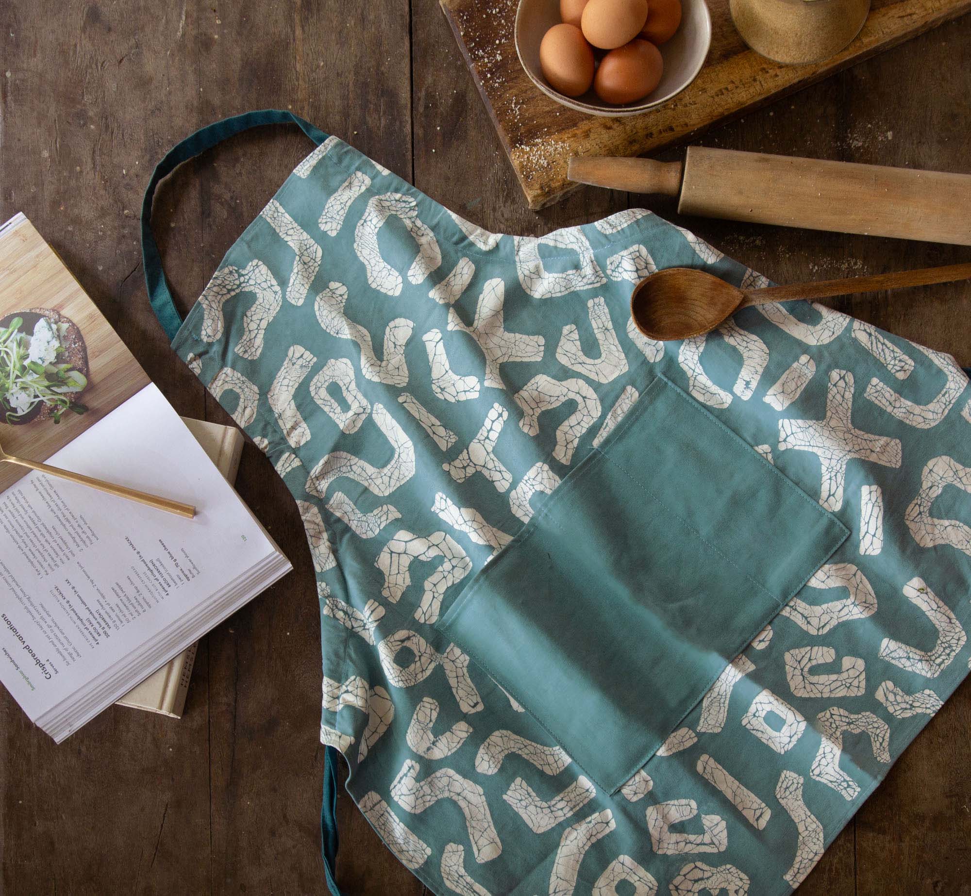 African handmade light blue apron adorned with a squiggle pattern.