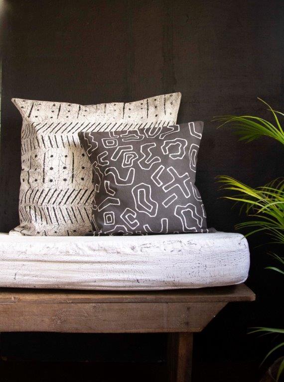 Eco-friendly cushion cover in charcoal grey with a bold graphic batik design, sustainable living spaces.