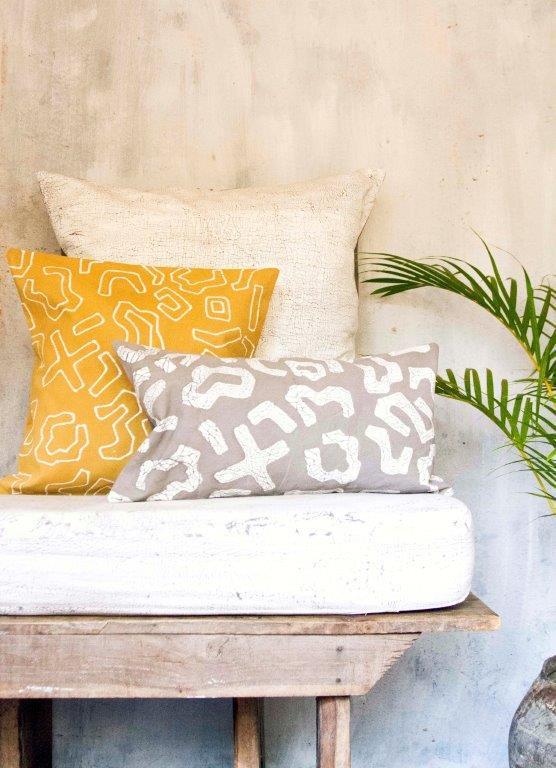 Artisan-crafted accent pillow cover in bright yellow, showcasing a dynamic graphic batik pattern for a  vibrant home.
