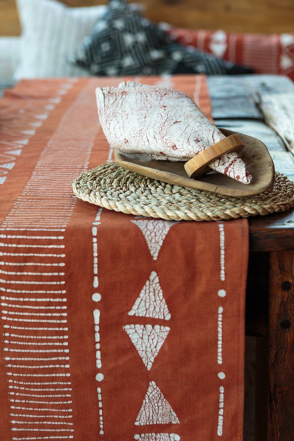 The perfect rust coloured table runner, adorned in geometric patterns and made using a traditional Batik technique.